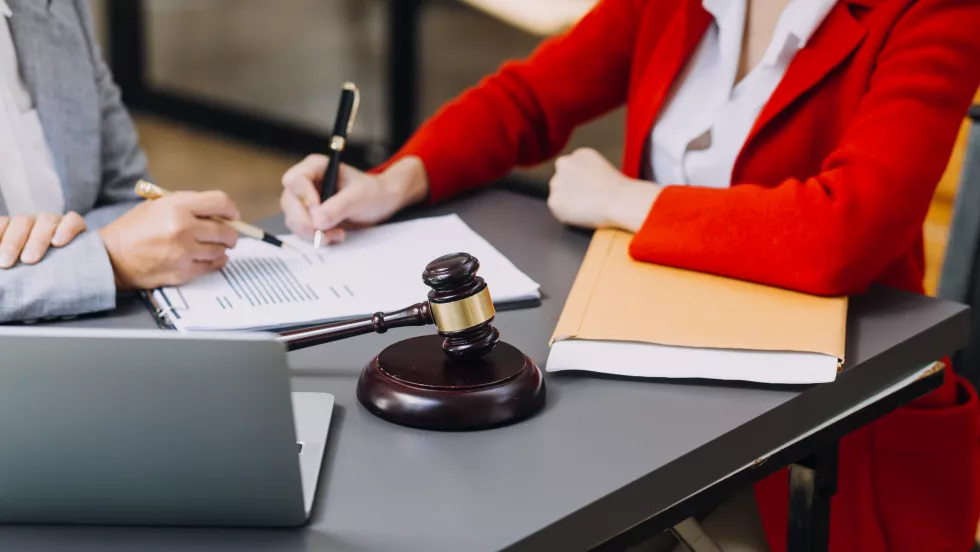 male-lawyer-working-with-contract-papers-wooden-gavel-tabel-courtroom-justice-law-attorney-court-judge-concept