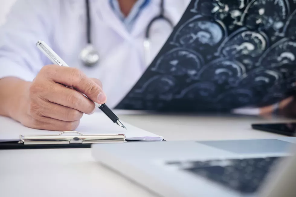 midsection-doctor-writing-paper-hospital