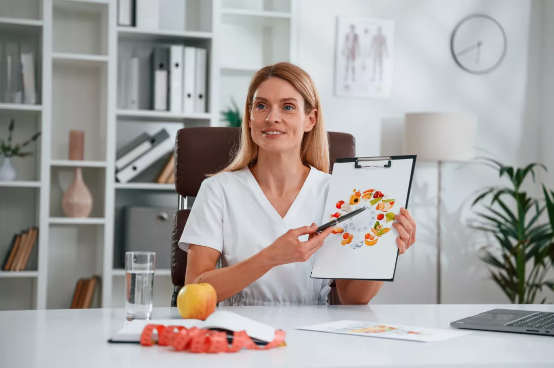 with-picture-food-vitamins-young-female-doctor-white-coat-is-indoors