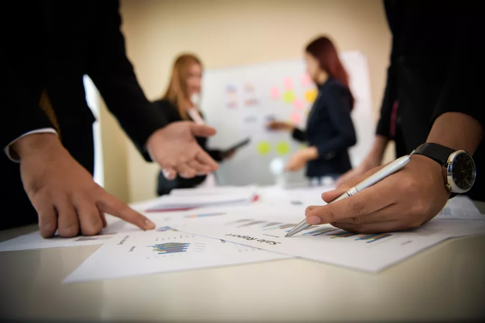 midsection-business-people-working-graph-table