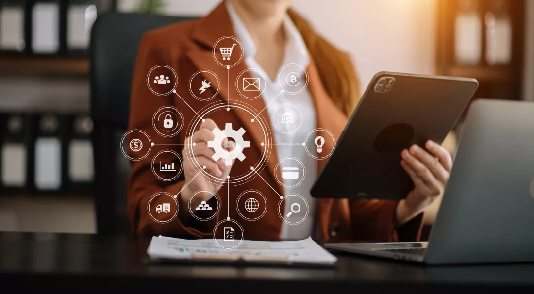 close-up-businesswoman-working-with-laptop-computer-smart-phone-desk-office-with-virtual-icon