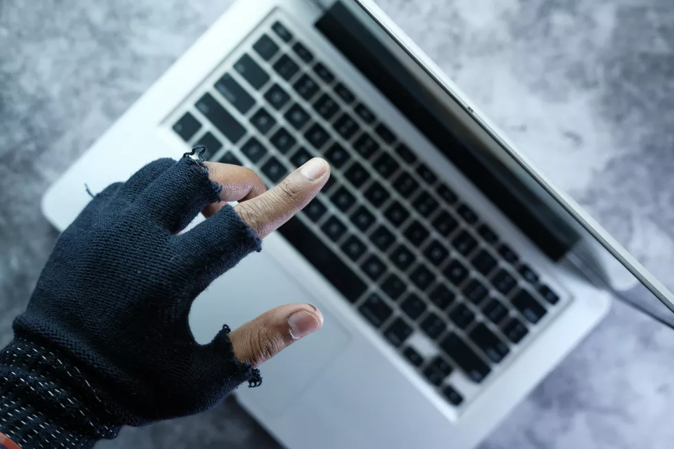 hacker-hand-pointing-finger-laptop-screen