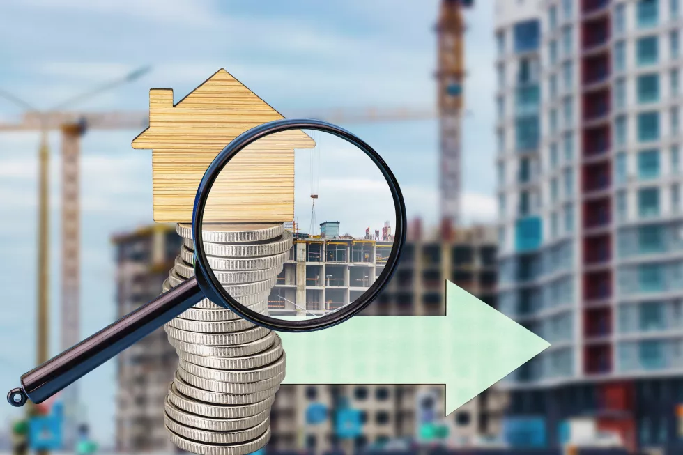stack-coins-with-keychain-form-house-magnifying-glass-background-construction-site-real-estate-mortgage-concept-buying-building-new-home-insurance-rent