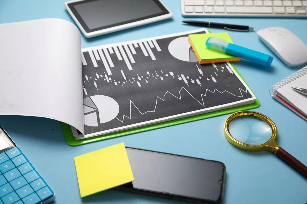 magnifying-glass-financial-graphs-other-business-objects