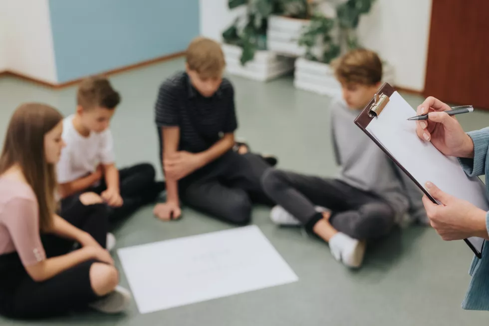 group-teenagers-sit-circle-floor-prepare-project-together