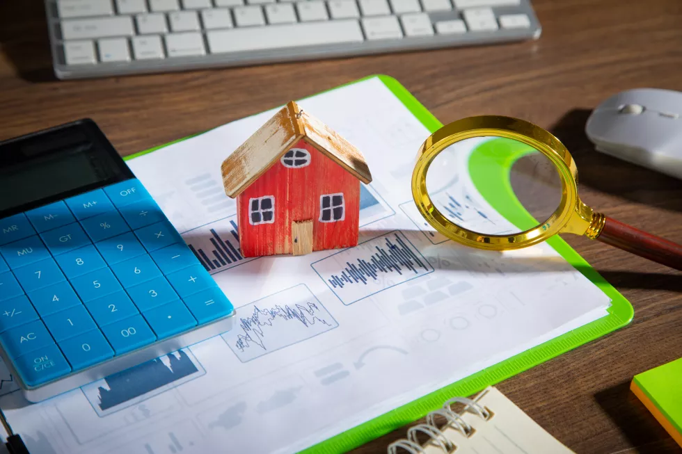 house-model-graphs-magnifying-glass-with-business-objects-table