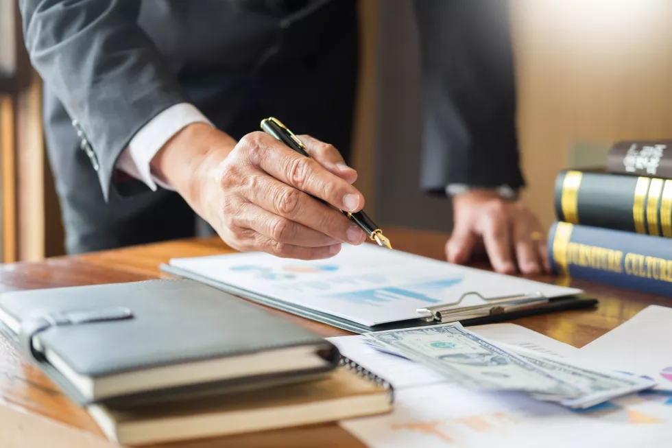 midsection-businessman-working-graph-desk-office