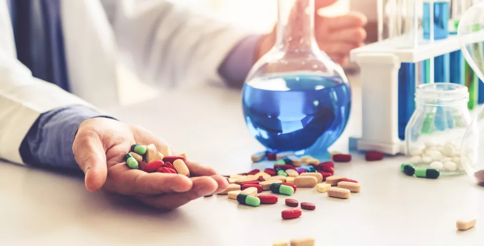 midsection-scientist-performing-experiment-table
