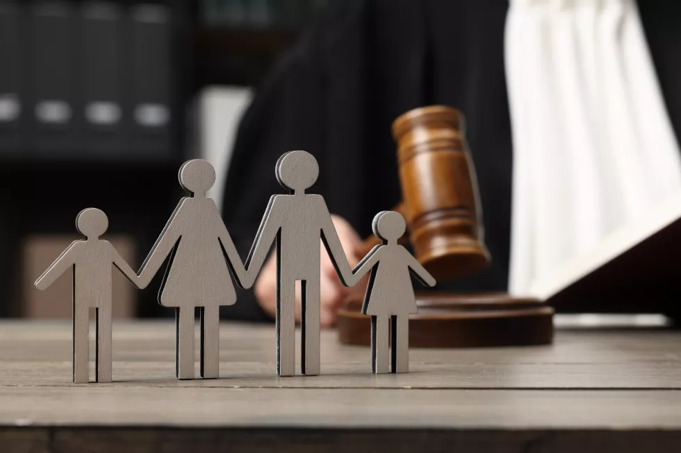 family-law-judge-with-gavel-sitting-wooden-table-focus-figure-parents-children
