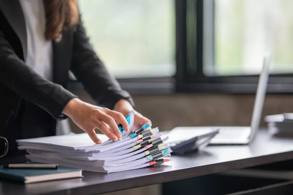 closeup-hand-asian-businesswoman-arranging-documents-her-desk