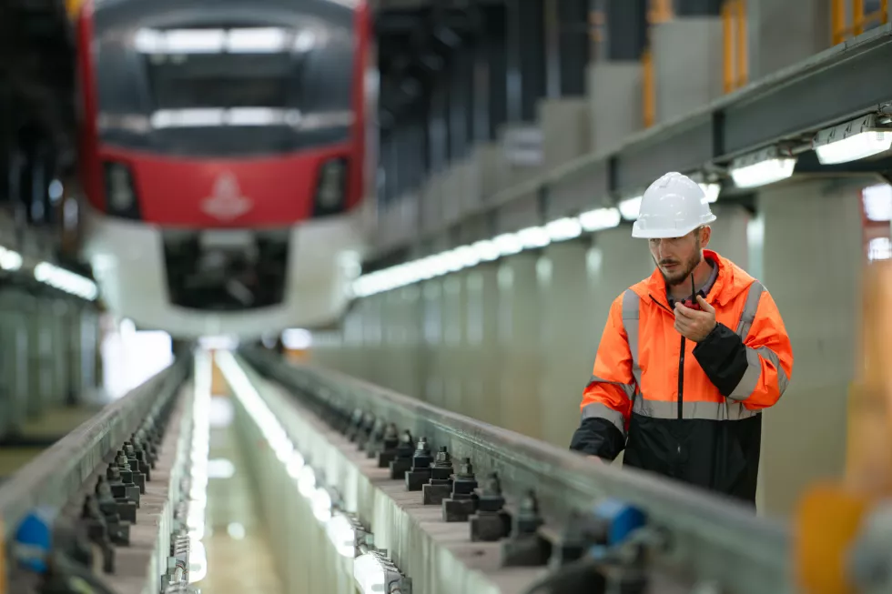 portrait-young-male-technician-using-walkie-talkie-working-standing-skytrain-repair