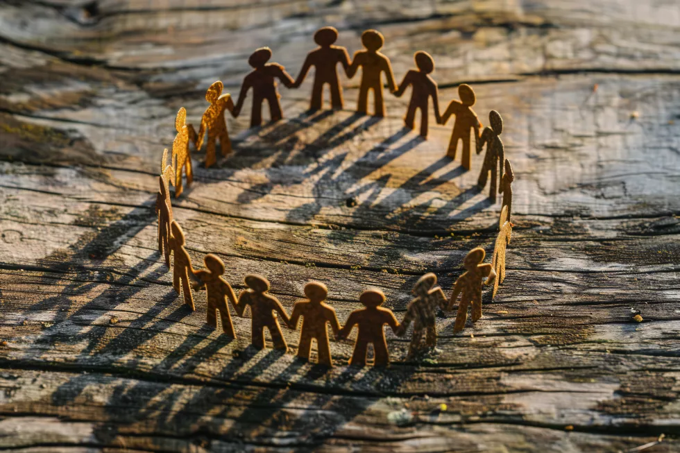 community-teamwork-concept-with-paper-cutout-people-holding-hands-circle