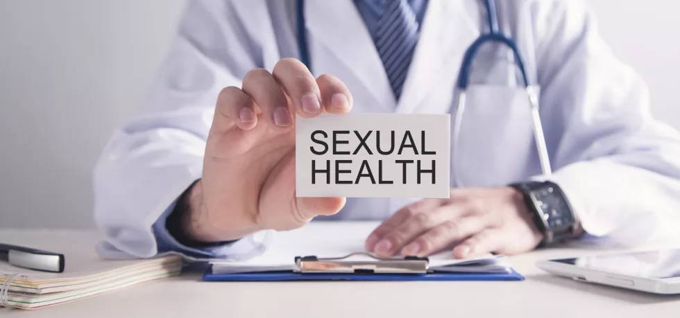 doctor-showing-sexual-health-text-business-card