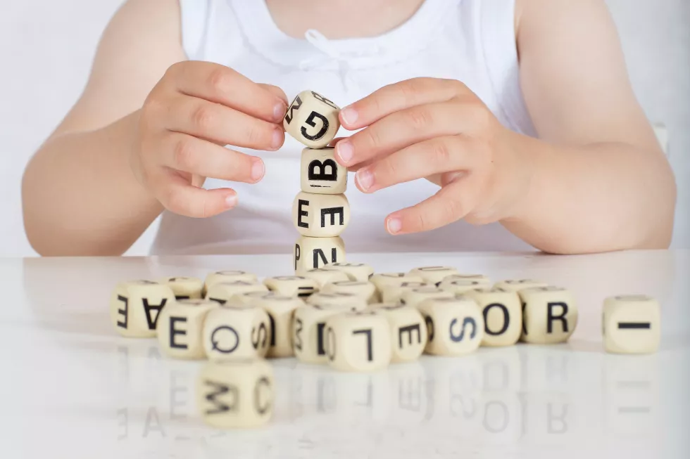 small-girl-two-years-composes-words-from-letters-closeup