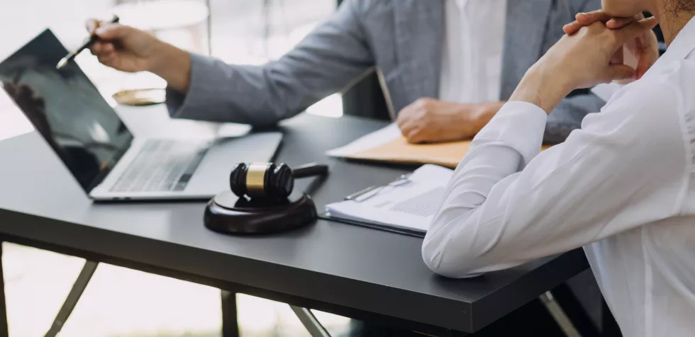 business-lawyers-discussing-contract-papers-with-brass-scale-desk-office-law-legal-services-advice-justice-law-concept-picture-with-film-grain-effect