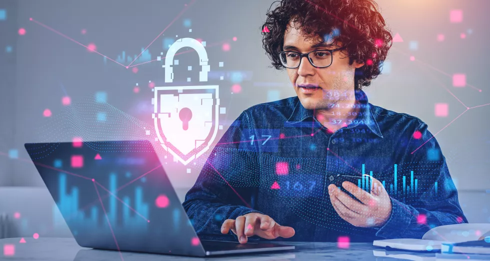 man-with-phone-laptop-data-protection-interface