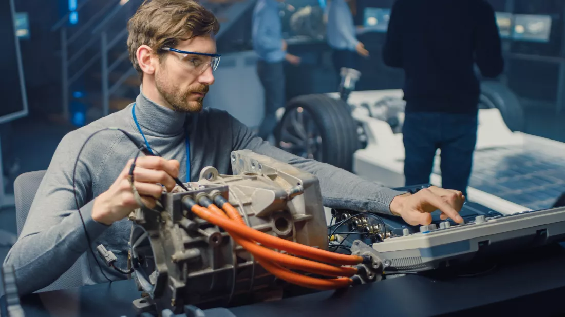 man-works-car-engine-with-wire-harness