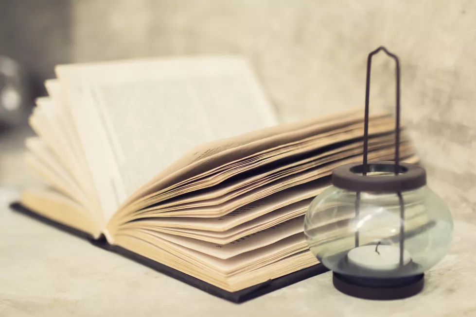 open-book-near-candle-close-up
